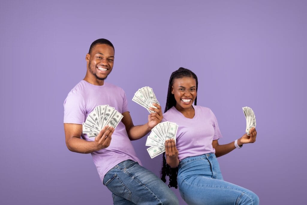 Couple each holding a fan of cash.