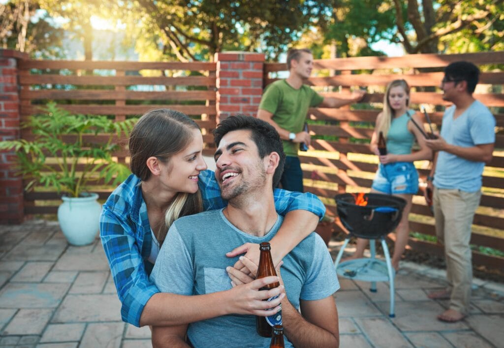 Couple spending time together at a bbq with friends.