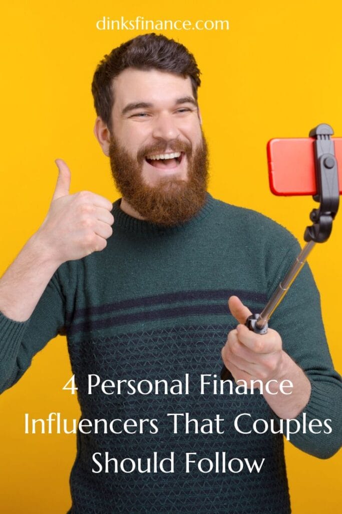 Man giving a thumbs up while holding a selfie stick and smiling into the camera