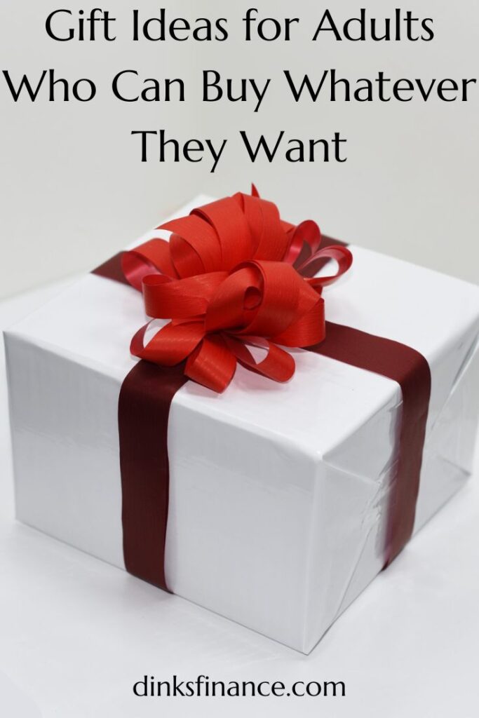 A box wrapped in white paper with a red ribbon.